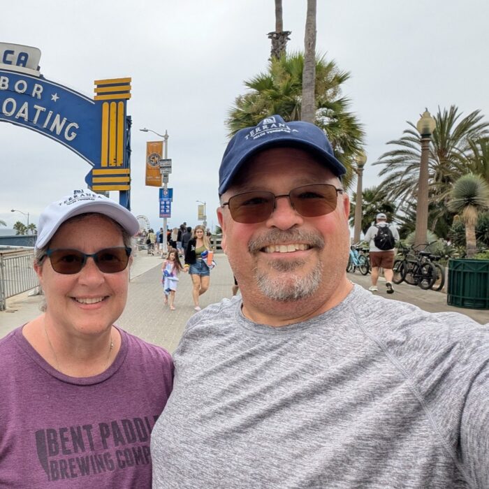 Dan Slick and wife on an oceanside boardwalk